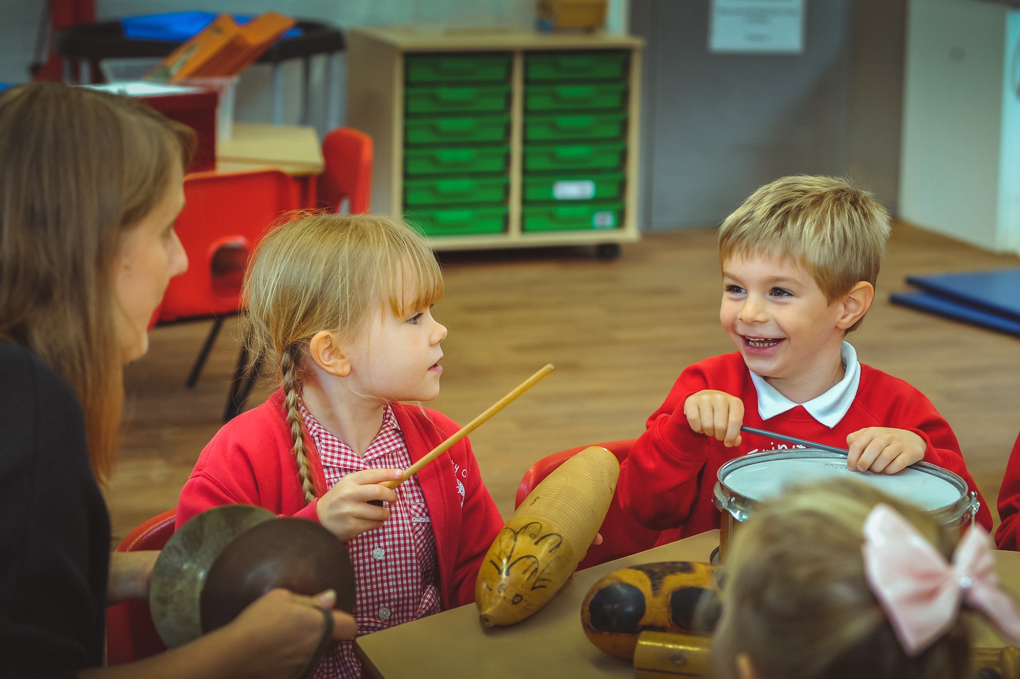 Two students in music class with teacher