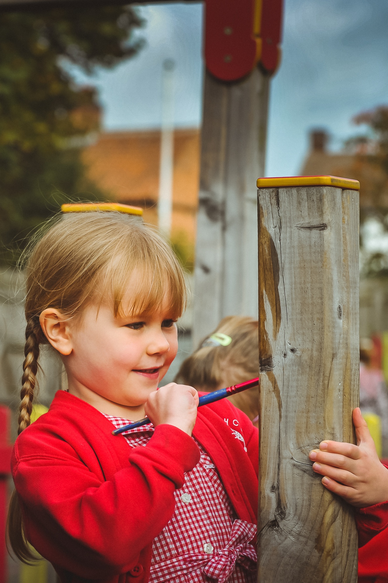 Child at break time with paint brush in playground
