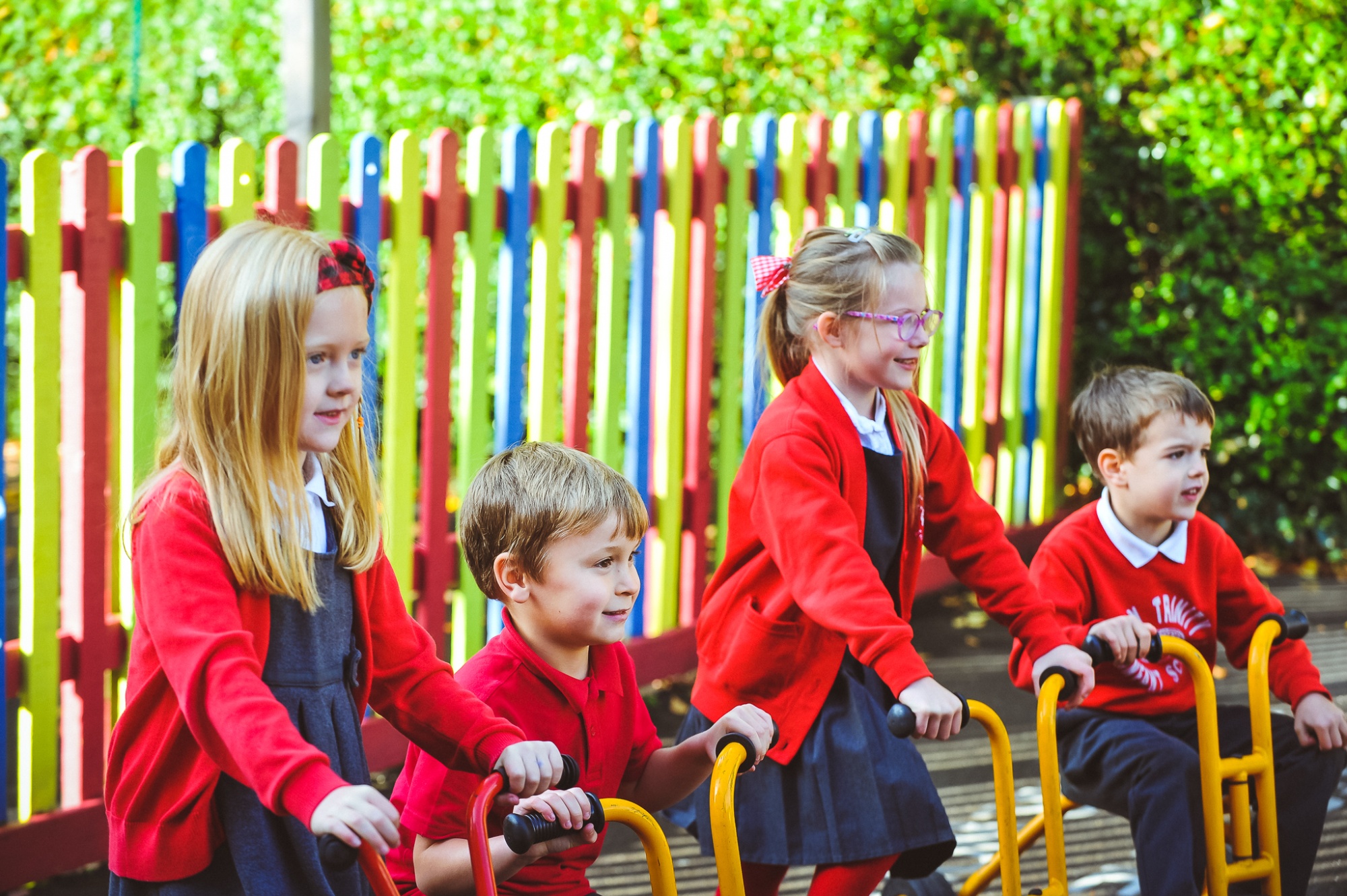 Four students in the playground on bikes