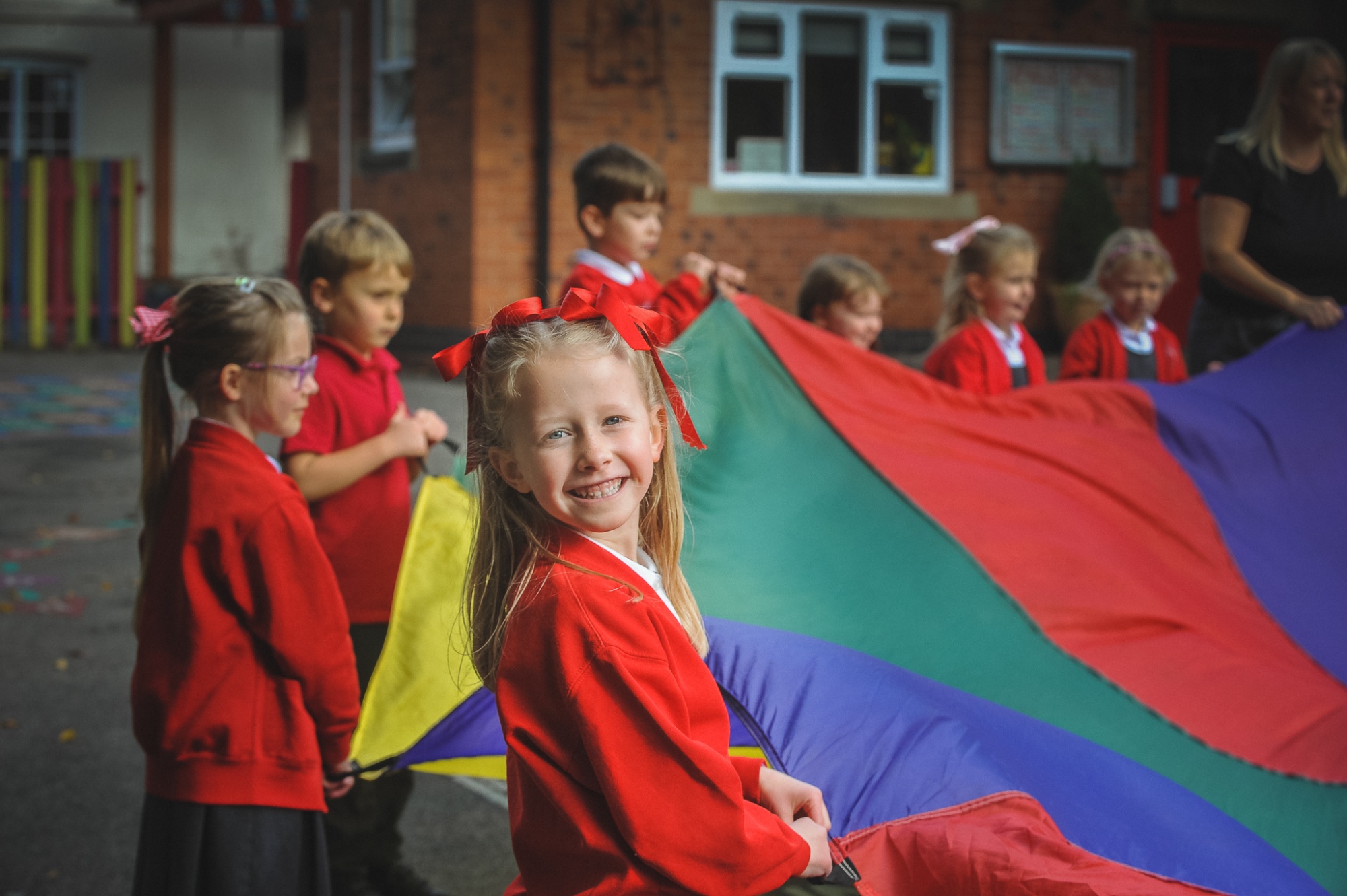 Students in the playground with large parachute