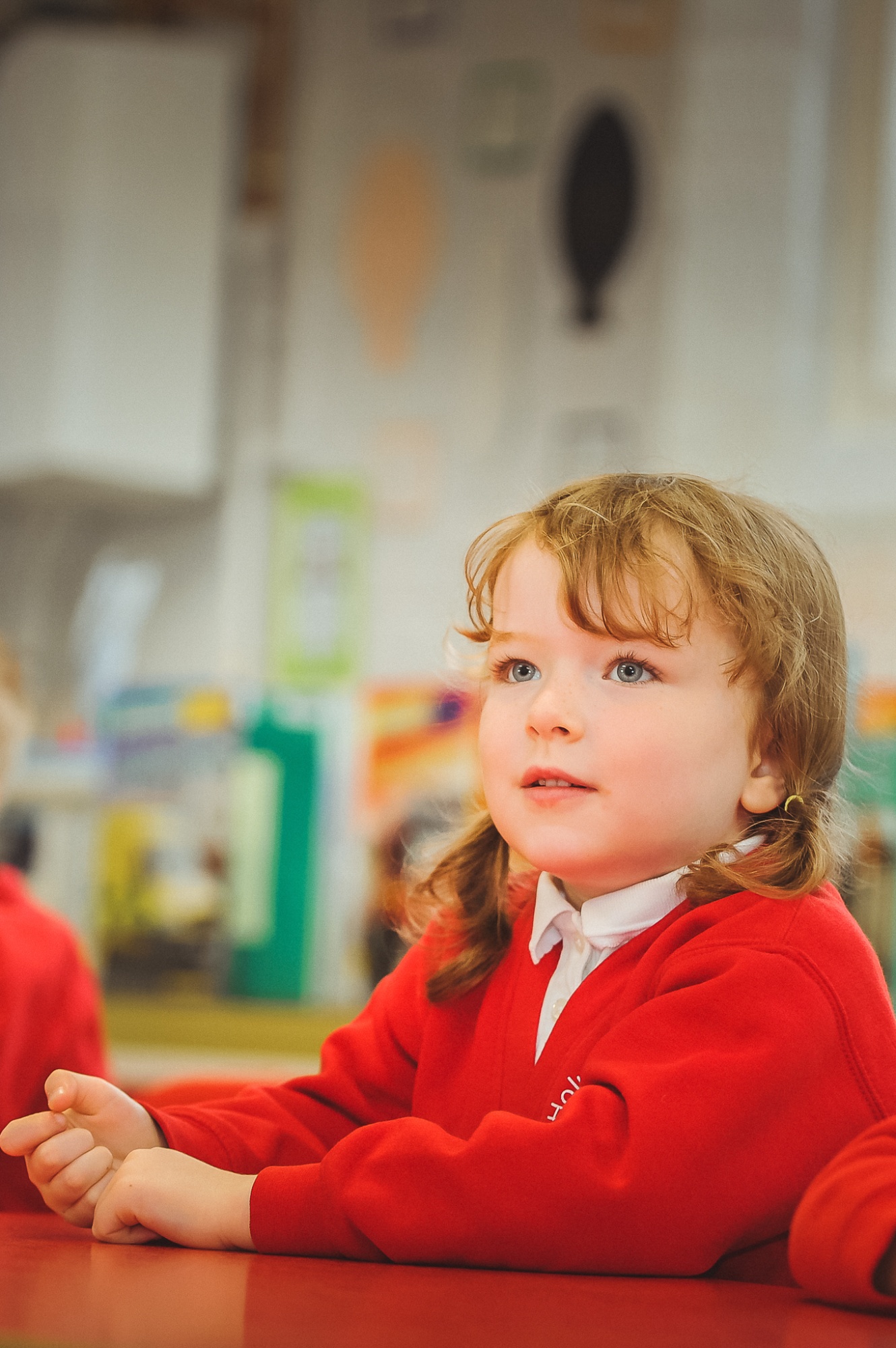 Child listening to teacher in class